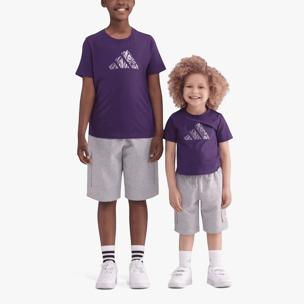 Two kids wearing matching purple Adidas Animal short sleeve tees with a white mountain logo, grey cargo shorts, and white