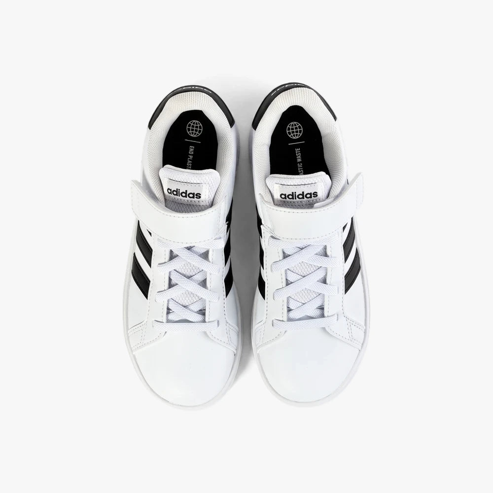 An overhead view of white Adidas Kids Grand Court 2.0 El sneakers with black stripes, white laces, and velcro closure.