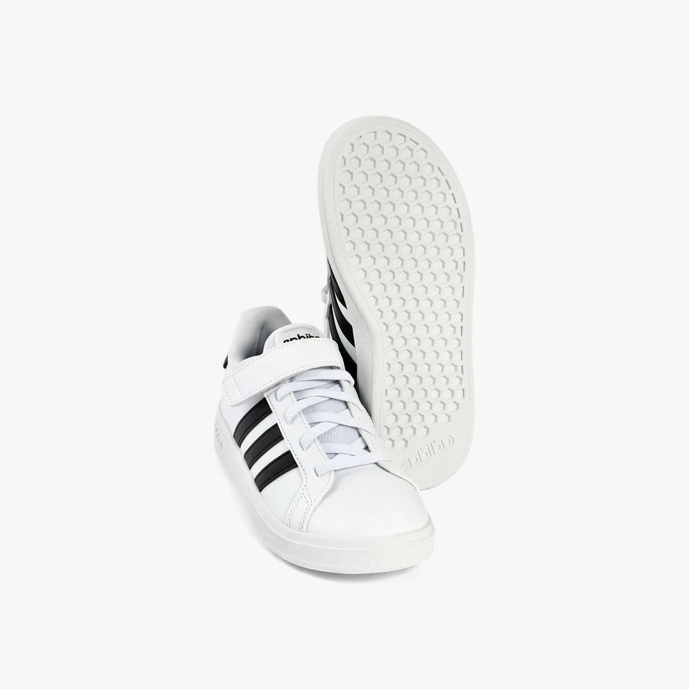 Adidas Kids Grand Court 2.0 El Sneaker in white with black stripes, featuring a Velcro strap and laces, displayed from a