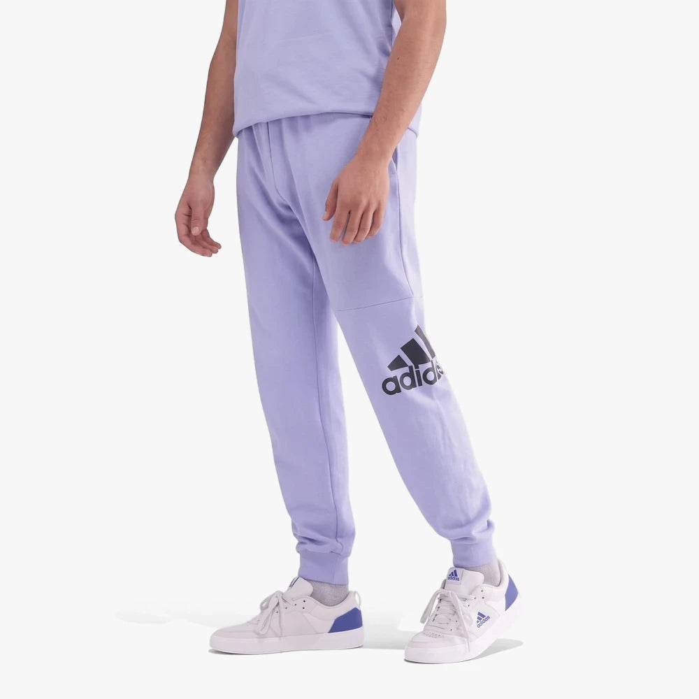 Adidas Mens Bl Ft Pt4 jogger pants in pre purple with a large black logo, paired with white sneakers on a model.