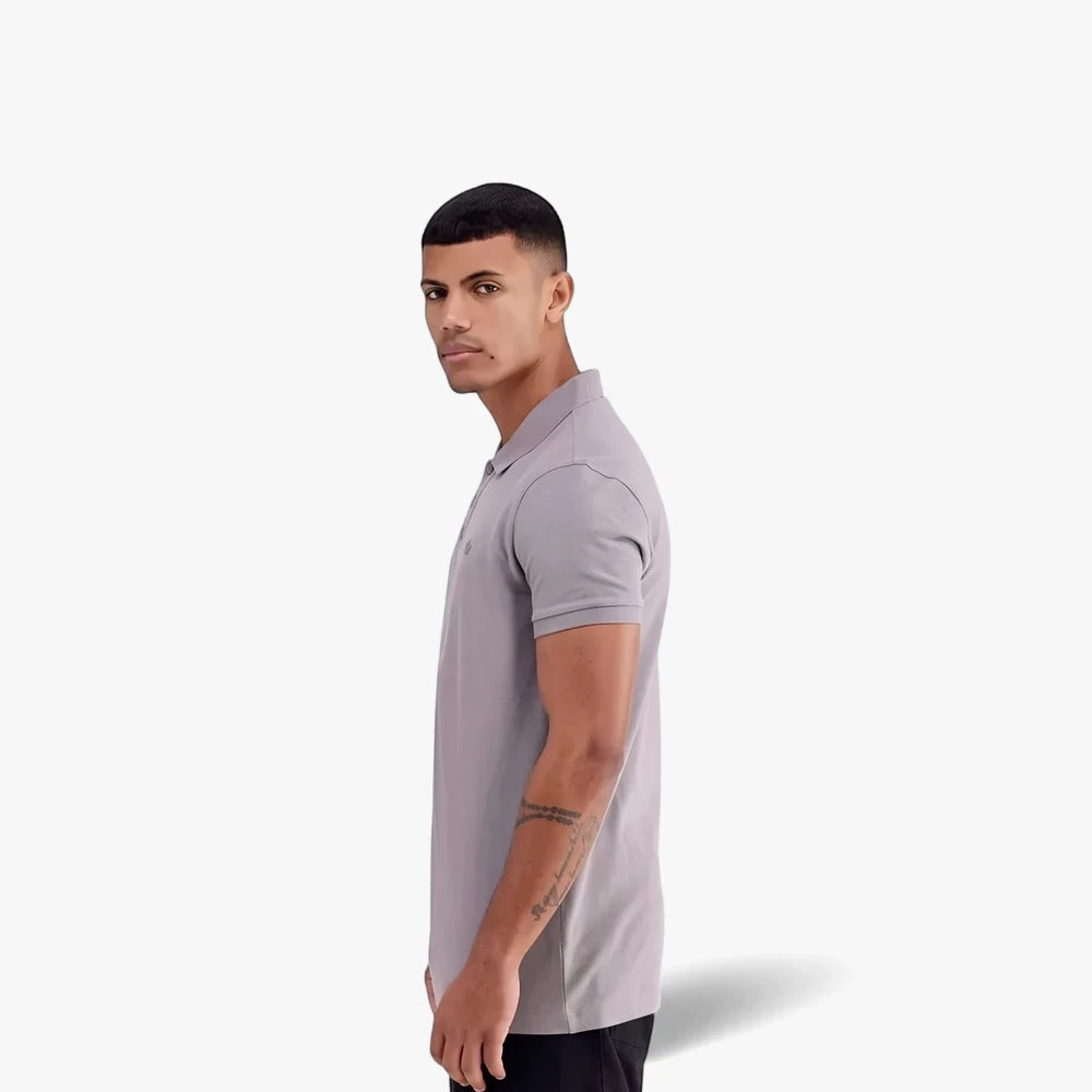 Adidas Mens Trefoil Essentials Polo Tee in grey, worn by a male model in a side profile view, looking over his shoulder at