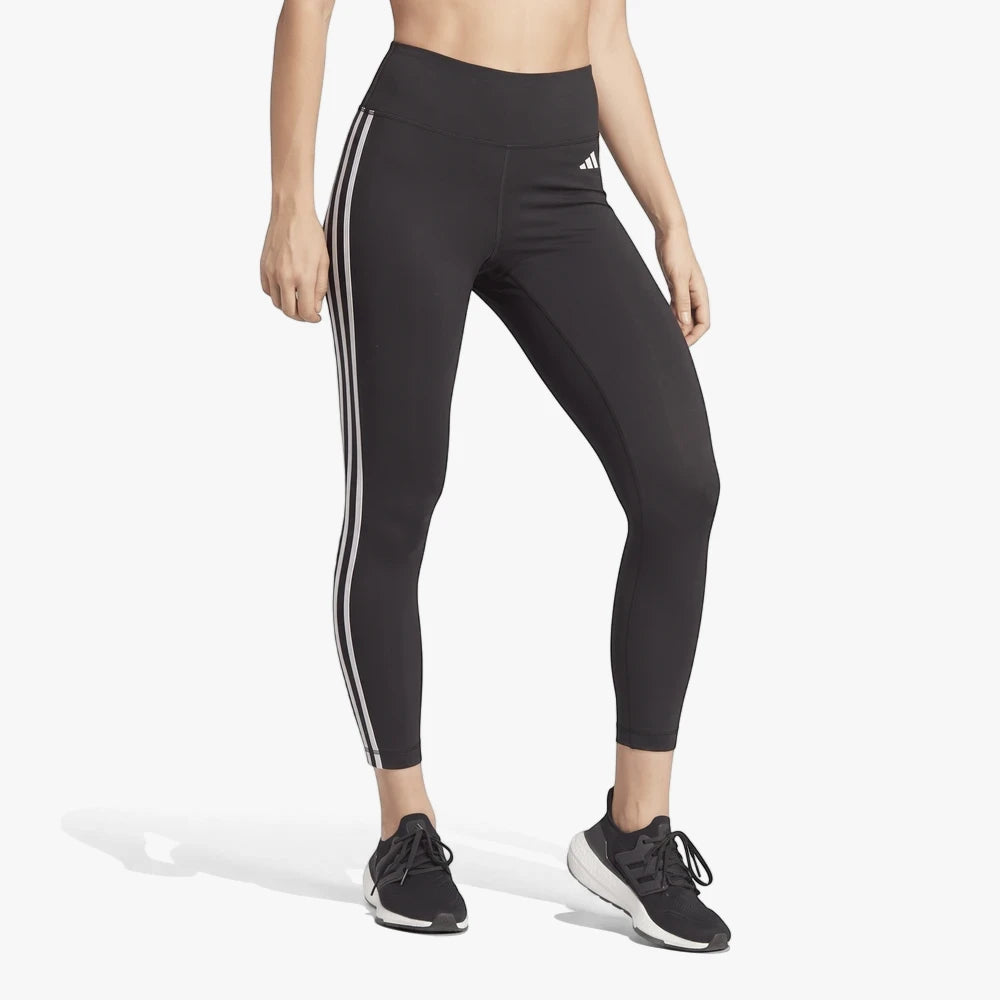 Adidas Womens 3 Stripe Tight Black leggings worn by a woman, featuring white iconic stripes and logo, in a cropped studio