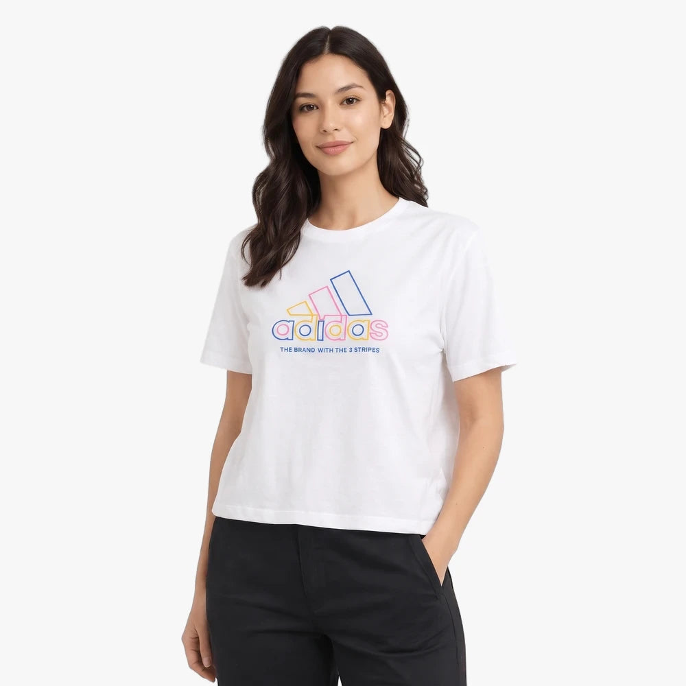 Young woman modeling a white Adidas Logo Short Sleeve Tee with a colorful outline logo, paired with black pants, smiling