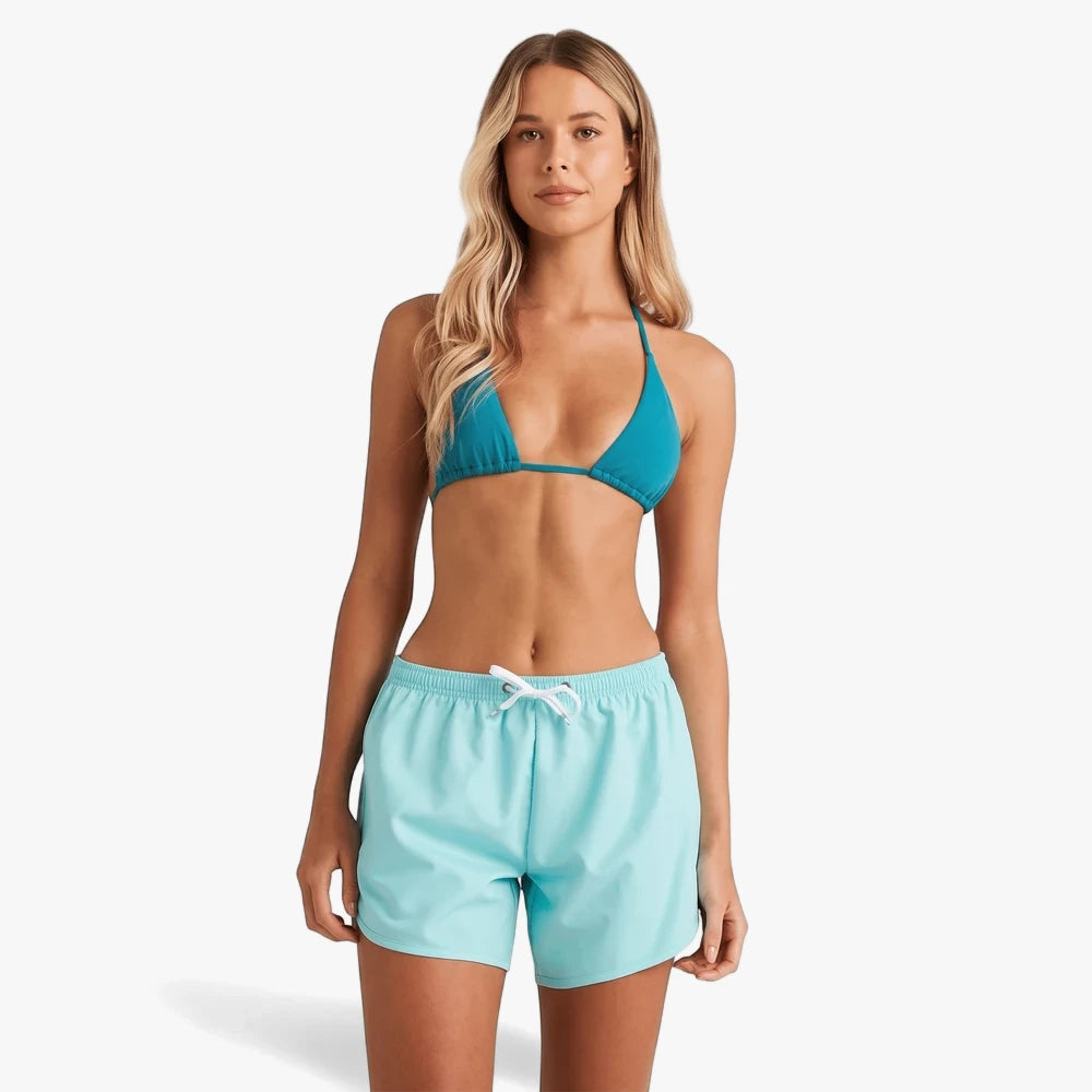 Billabong Womens Fun Times High Tide Boardshorts in light blue, worn by a woman with a blue bikini top.