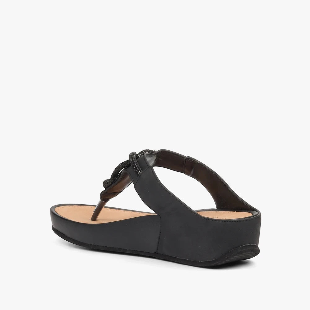Butterfly Womens Delia 14 Wedge Sandal in black, featuring textured straps and a platform sole, presented in a side view.