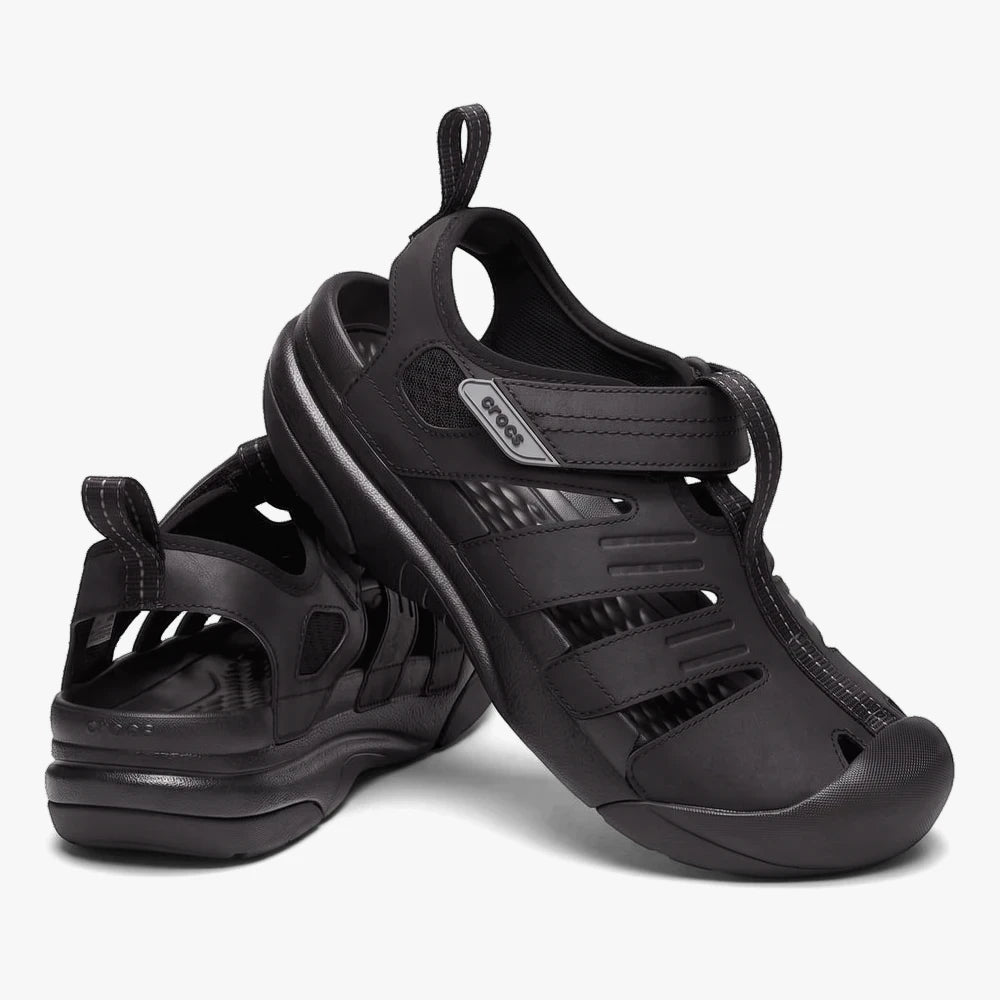 Pair of black Crocs Mens Yukon Fisherman sandals with closed toes and adjustable straps, shown angled against a white