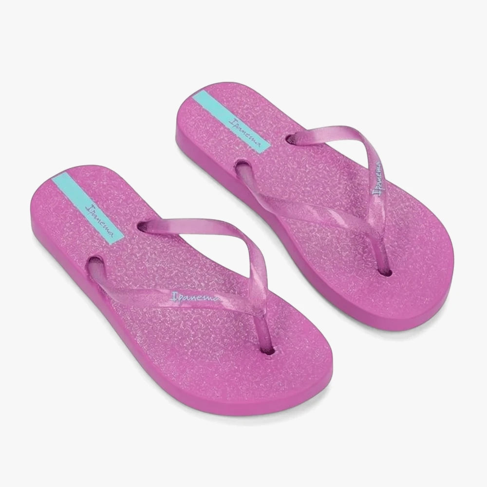 A pair of Ipanema Girls Glitter Sandals in lilac, featuring shimmering straps and a distinct blue stripe logo, angled for