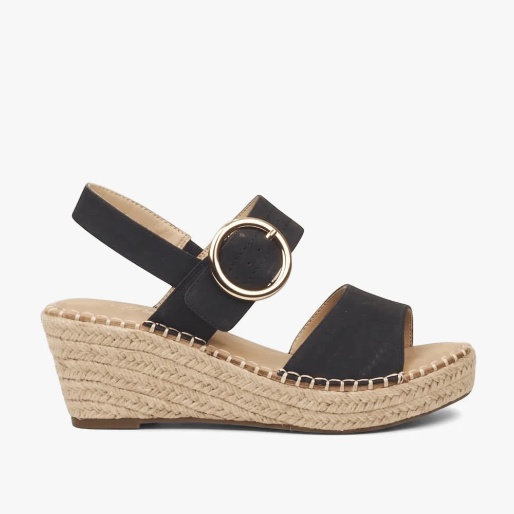 Miss Black Womens Jayda 9 black espadrille wedge sandal with an open toe, ankle strap, and gold circular buckle, viewed from