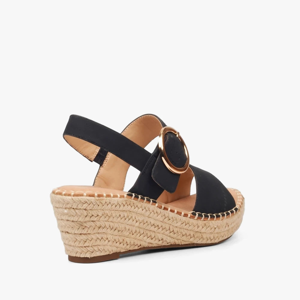 Miss Black Womens Jayda 9 black wedge sandal with an espadrille sole and a gold buckle, shown from a side-rear view.