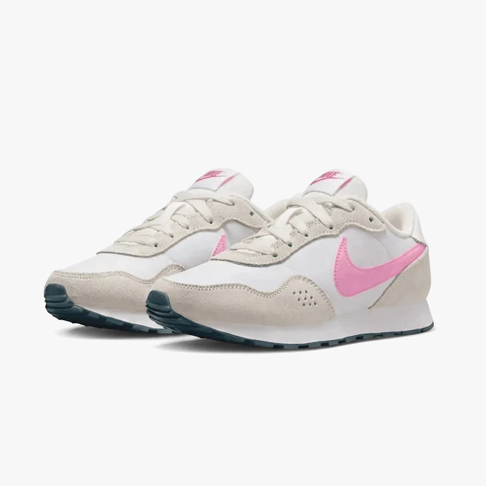 A pair of Nike Girls Md Valiant sneakers in grey and pink, presented from a side view.
