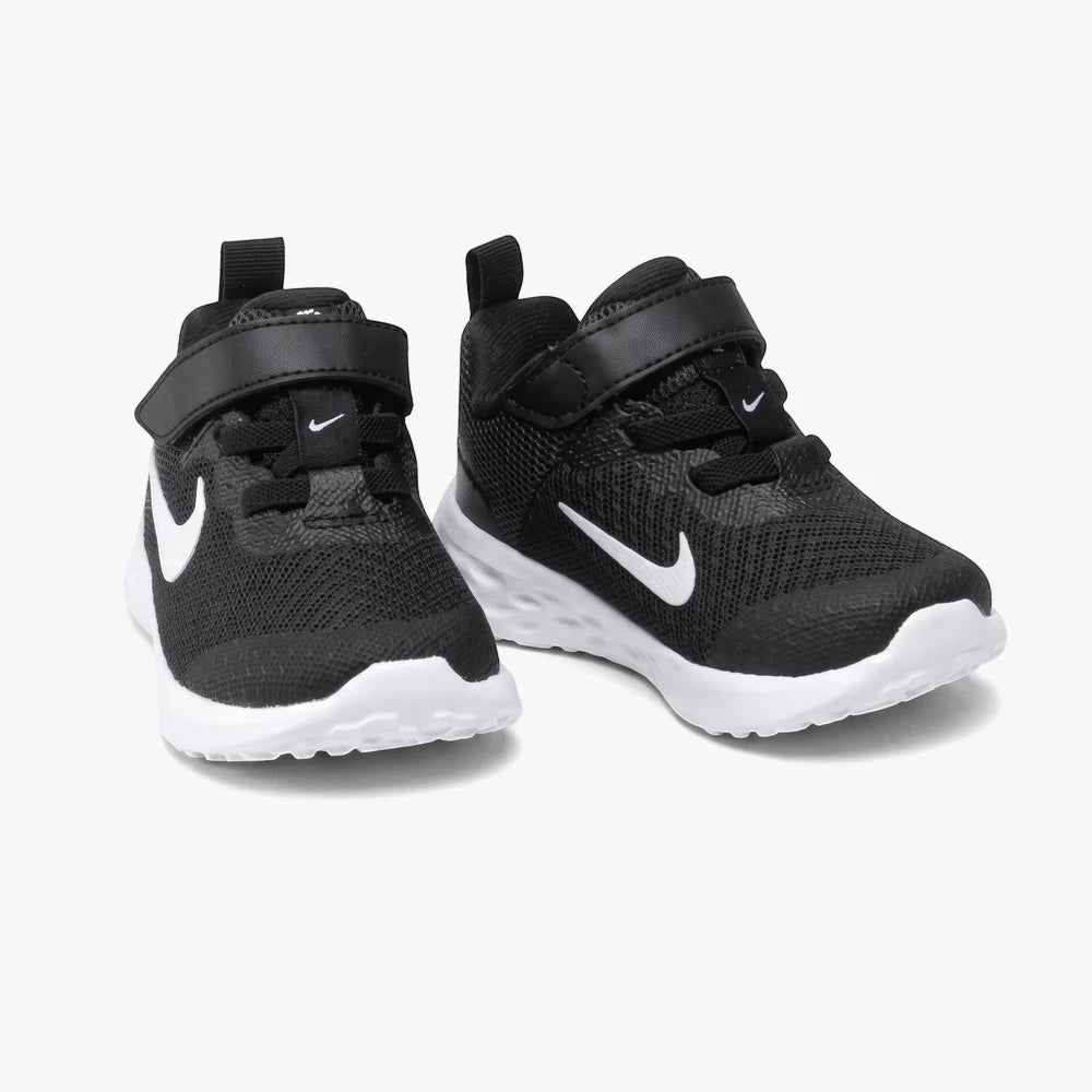 Black Nike Infant Boys Revolution 6 sneakers with white swooshes and soles, angled side by side.