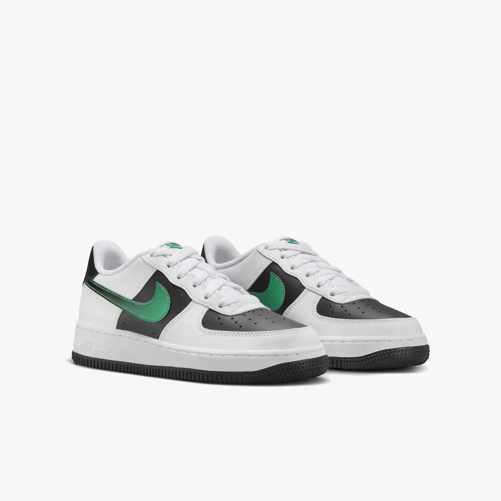 A pair of Nike Kids Air Force 1 sneakers in white, black, and green, displayed from a side view.