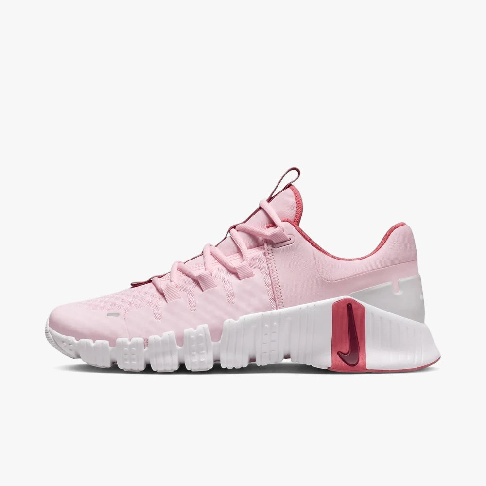 Nike Womens Free Metcon Sneaker in pink foam and white, shown from a side view on a plain background.