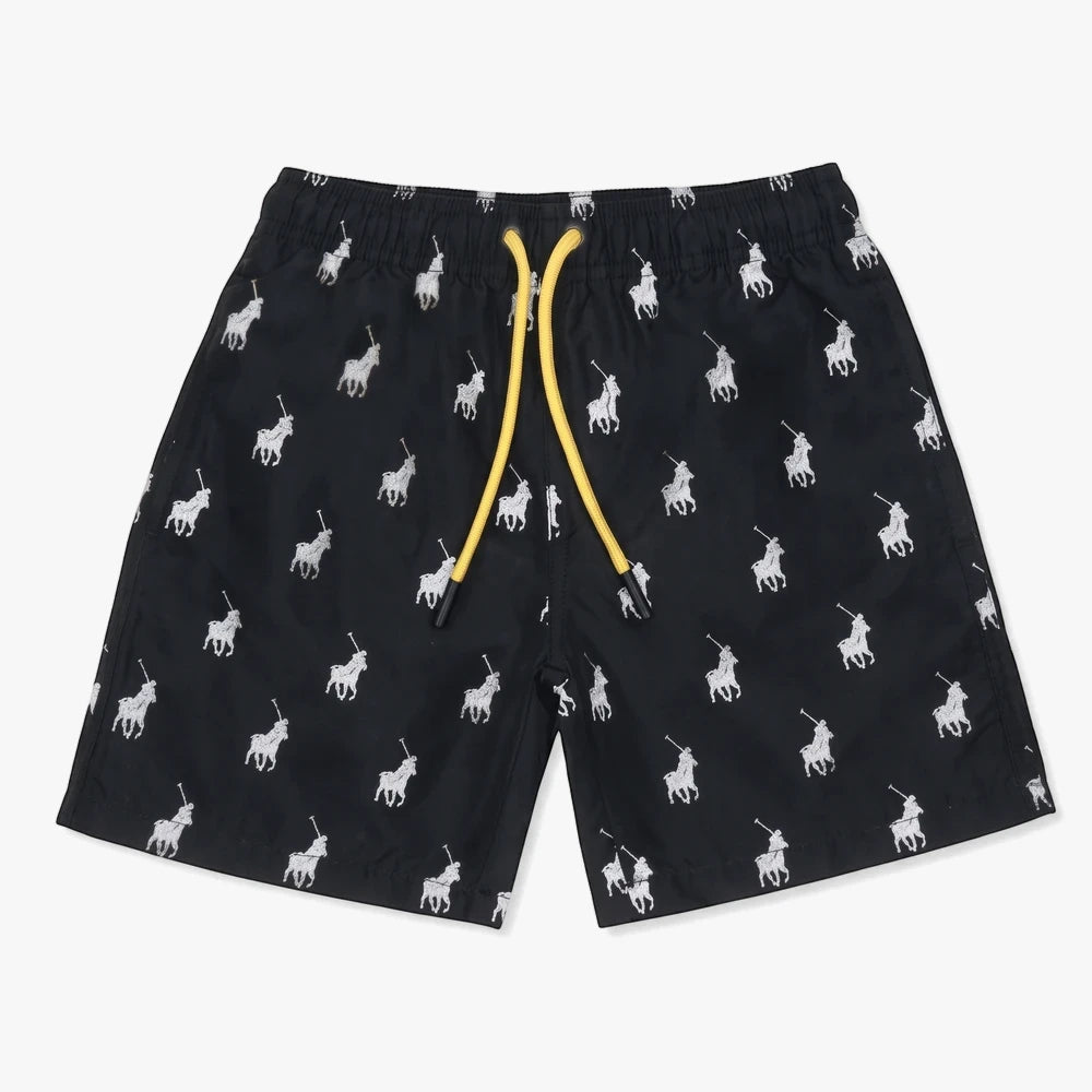 Polo Boys Bradley Monogram Beach Shorts in navy blue with a white polo player pattern and yellow drawstring, shown flat lay