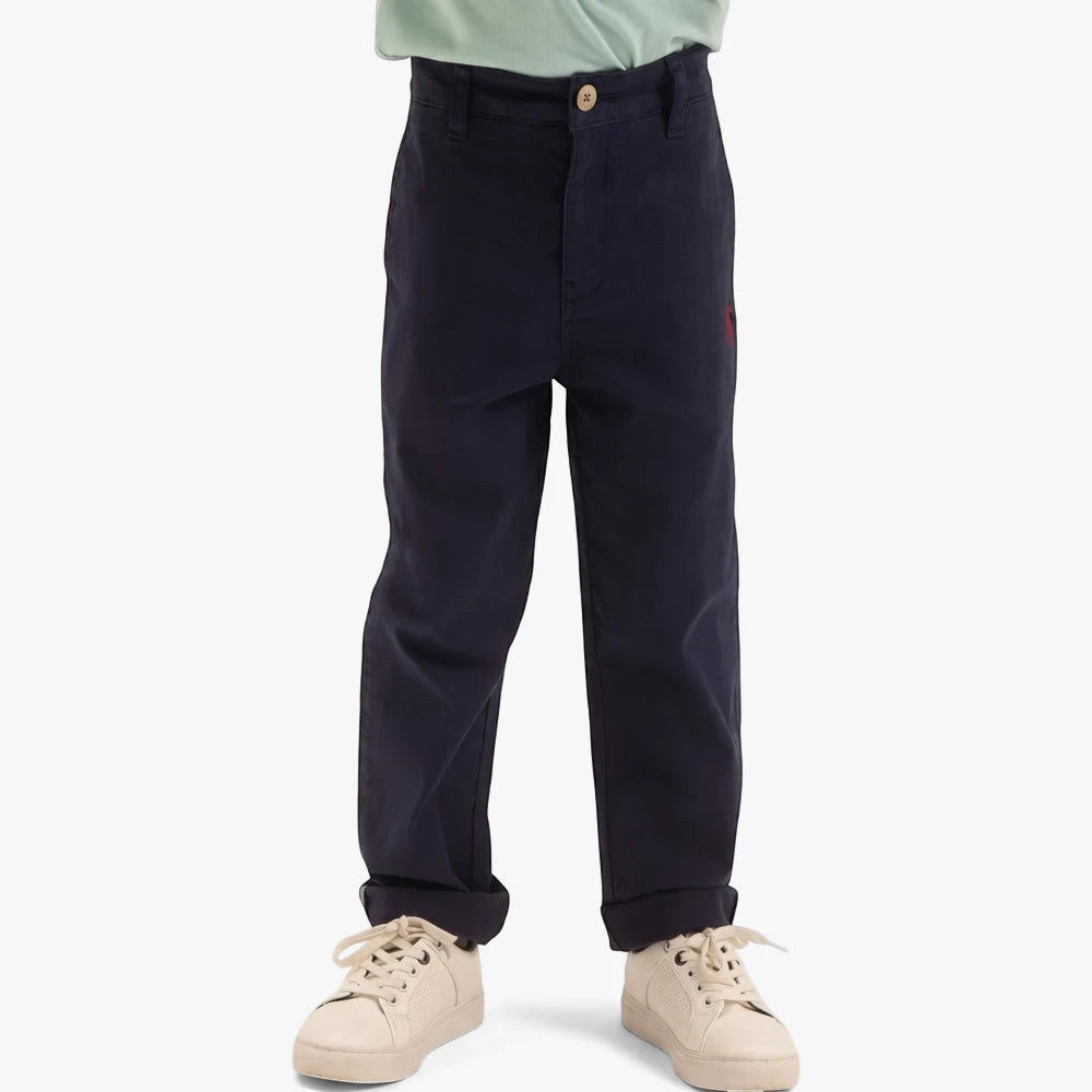 Navy blue Polo Boys Logan Classic Chino Pants, worn by a child, featuring rolled cuffs and a comfortable fit.