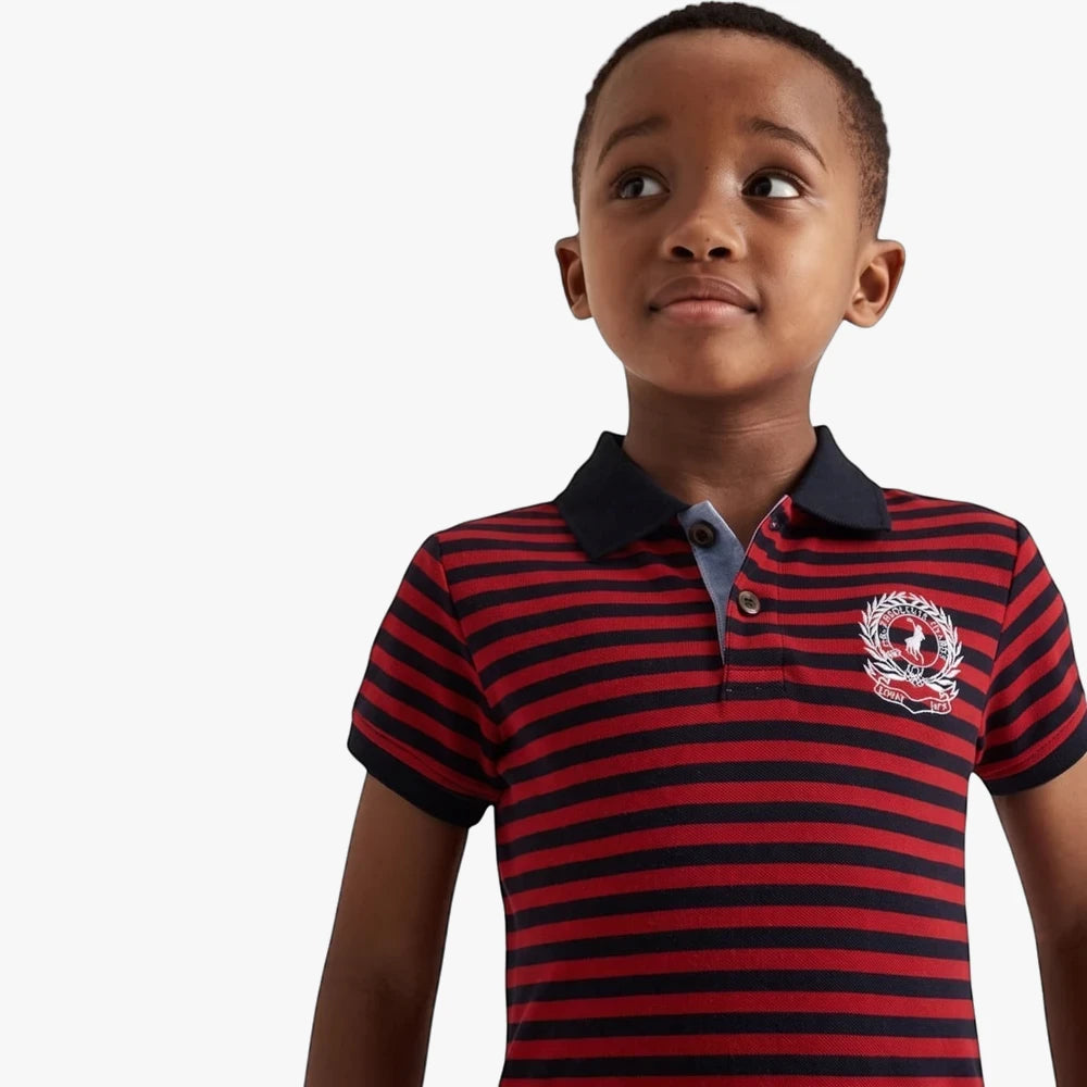 African American boy wearing a Polo Warren Striped Short Sleeve Golfer Red, featuring red and navy horizontal stripes and a