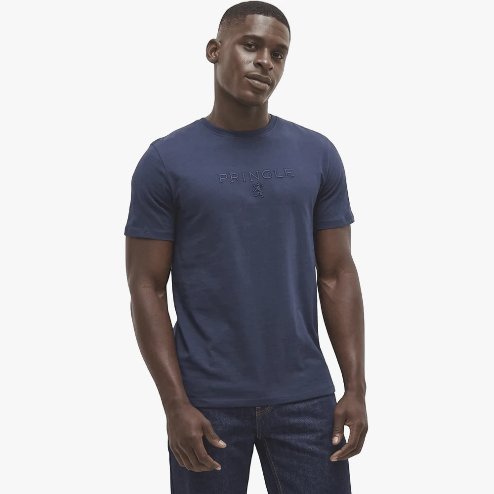 Navy Pringle Mens Ace short sleeve tee on a male model, showcasing the embossed brand logo on the chest and dark wash jeans.