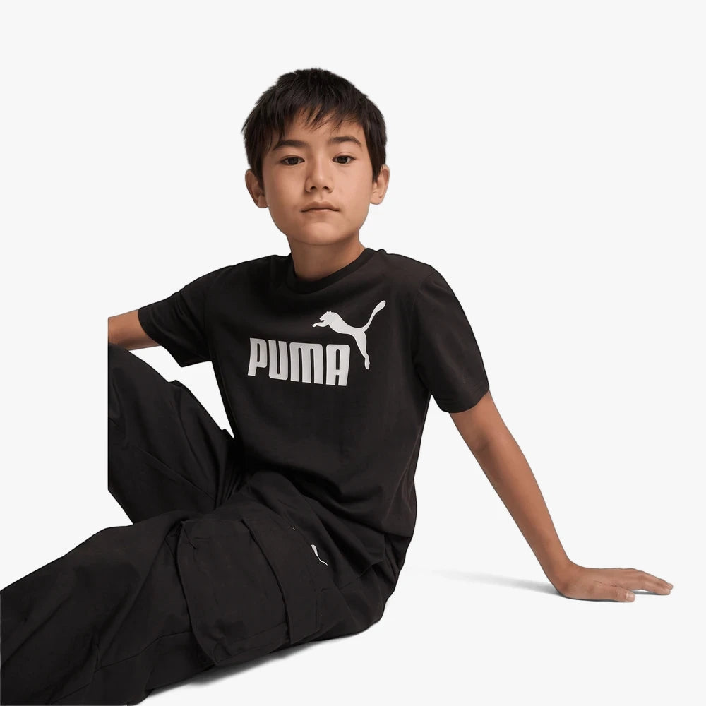 Puma Boys Ess No 1 Logo Short Sleeve Tee in black, featuring the iconic white Puma logo and text on the chest, worn by a