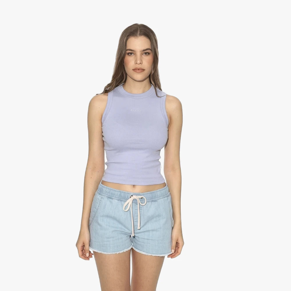 Woman wearing a lilac Ripcurl Womens Search Classic Rib Tank Top and light blue denim shorts, standing on a white background.