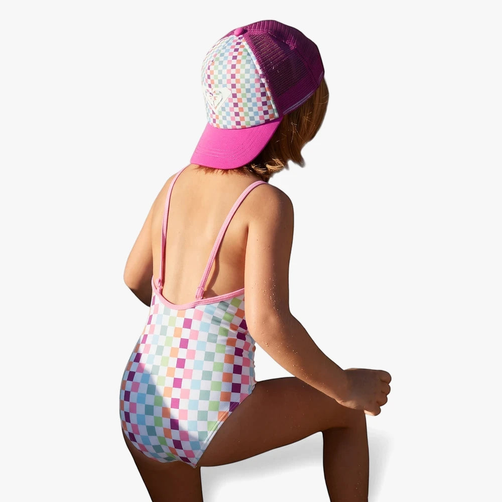 Young girl wearing a colorful Roxy Girls Rainbow Check One Pc Swim Suit in pink and multi-color, viewed from behind.