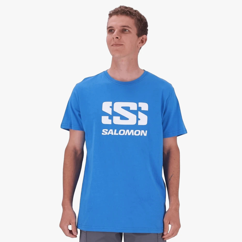 A young man models a Directoire Blue Salomon Mens Adventure Short Sleeve Tee with a white brand logo, standing front-facing.