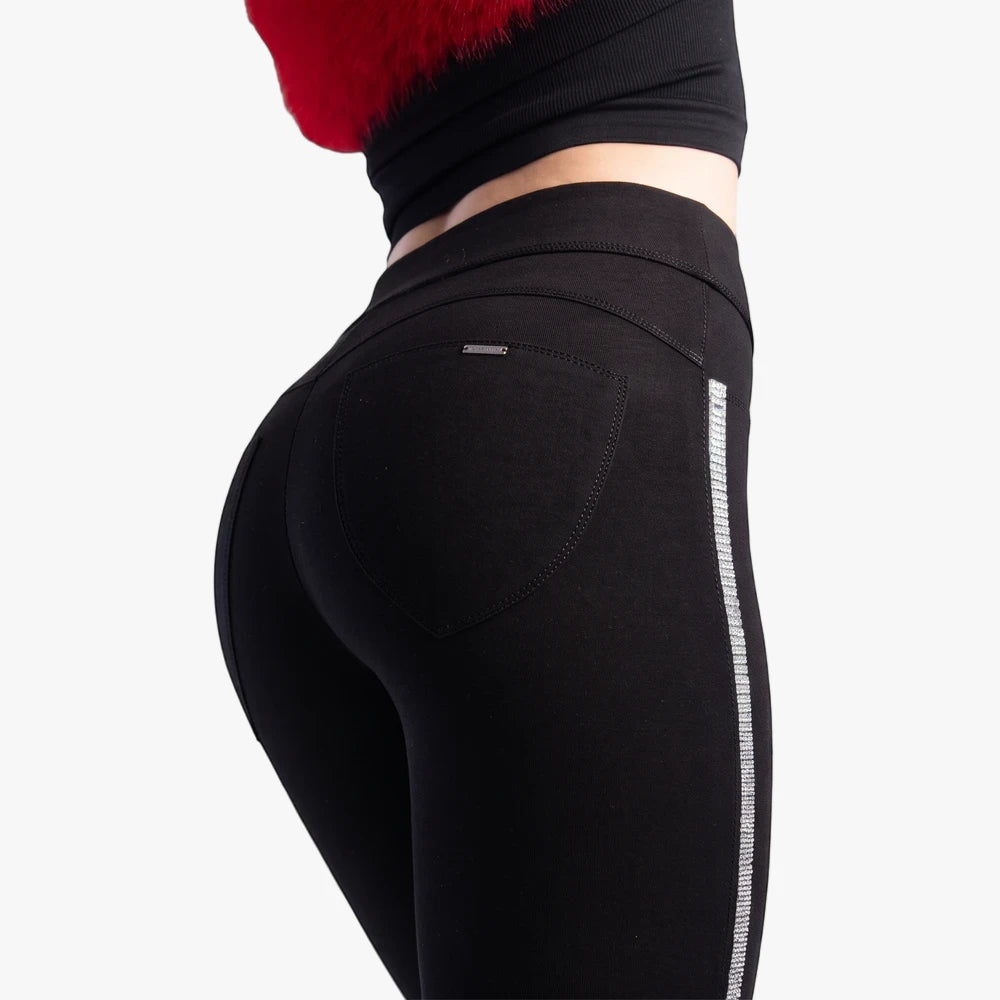 Close-up of black Sissy Boy Joey Sculpt Knit Jeggings with sparkly silver diamante tape side detail, worn by a model from