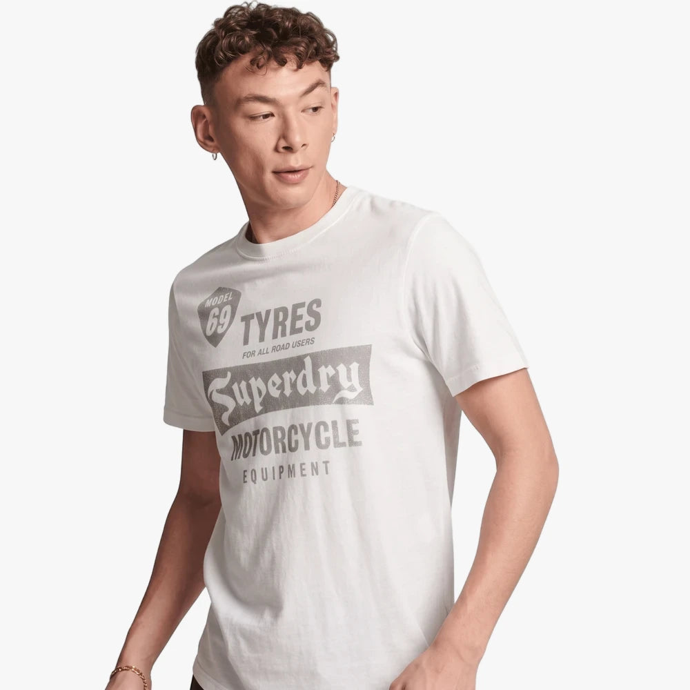 Young man wearing a Superdry Mens Vintage Reworked Classic Tee in winter cream with a gray &