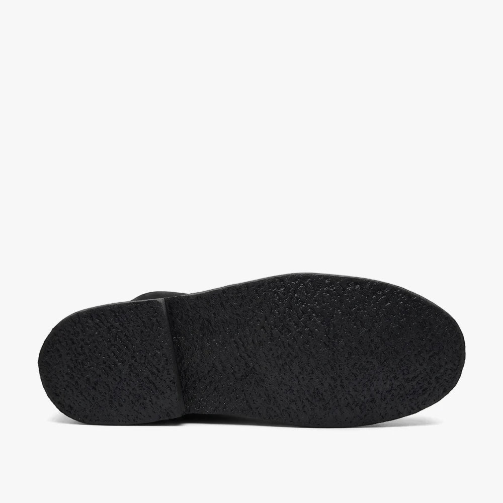 Black mono Survivor Hunter Vellies boot, showcasing its textured sole in a bottom view against a clean background.