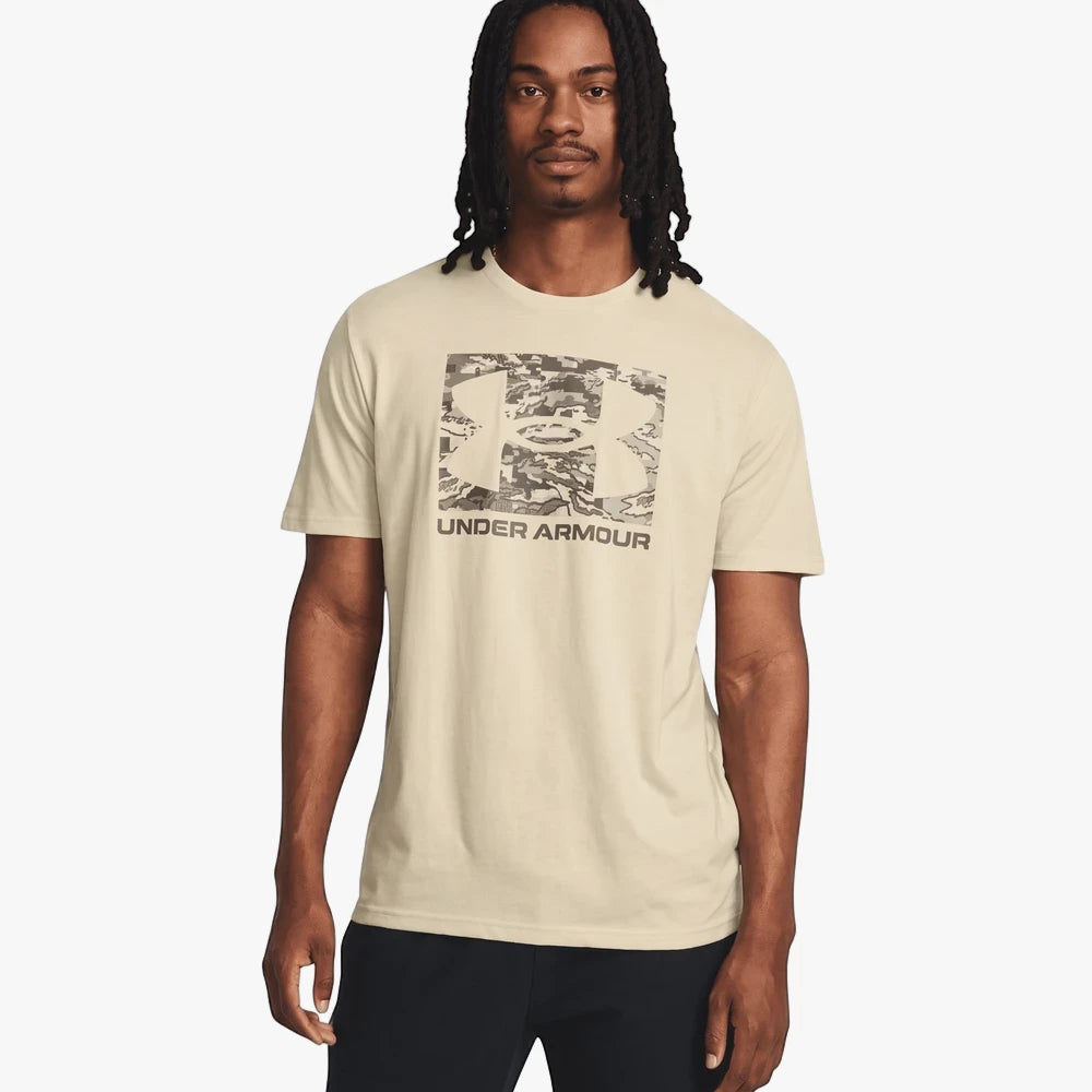 Under Armour Mens Abc Camo Boxed Short Sleeve Tee in beige, featuring a camouflage logo. Front view of a man wearing the