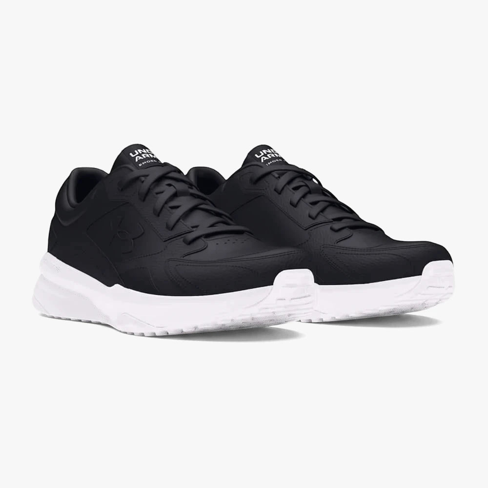 Pair of black Under Armour Mens Edge Leather Sneakers with white soles, viewed at an angle on a white background.
