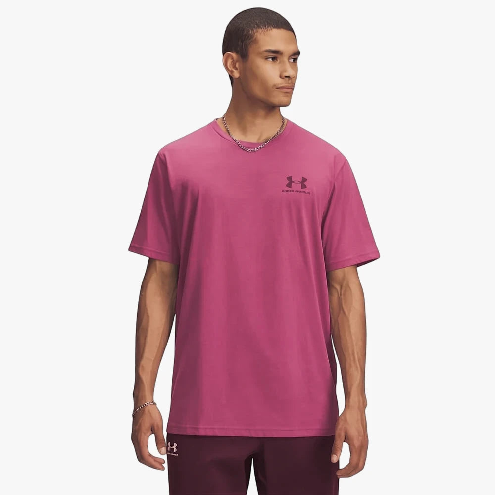 Male model wearing a pink Under Armour Mens Sportstyle Left Chest Short Sleeve Tee. Front view of the t-shirt.