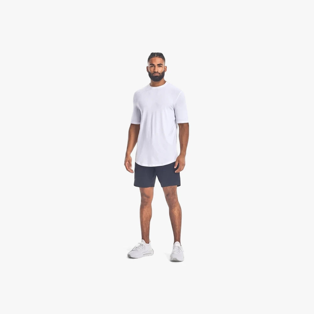 Full body view of a man wearing Under Armour Mens Unstoppable Shorts 001 Black, a white t-shirt, and white athletic shoes.