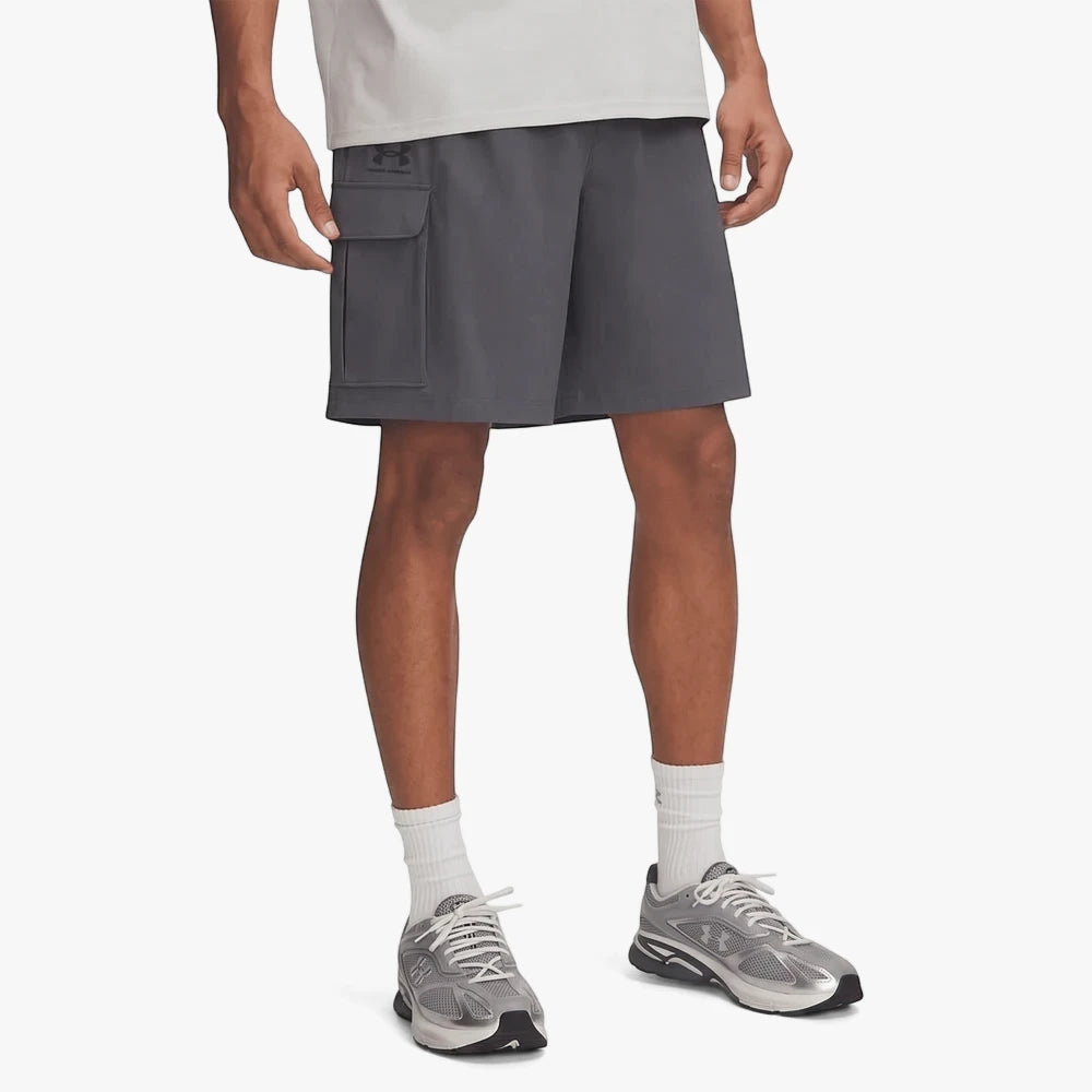 Under Armour Mens Vibe Woven Cargo Shorts in Castlerock grey worn by a model, showing the side cargo pocket and athletic