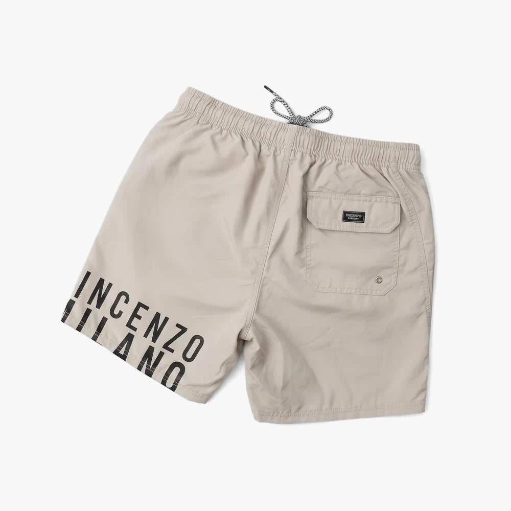 Vincenzo Milano Mens Swim Shorts in beige, featuring a relaxed fit, black drawstring, and back pocket, displayed from a back