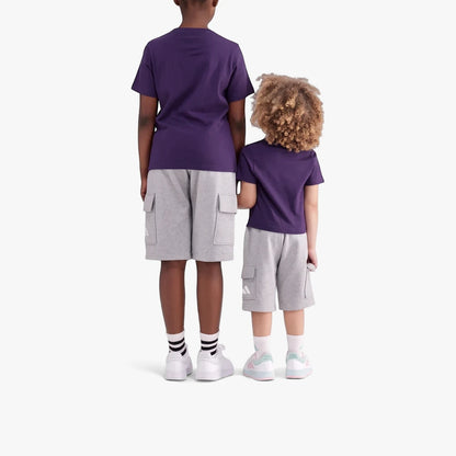Two children from behind wearing purple Adidas Kids Animal Short Sleeve Tees and gray cargo shorts, standing side by side.