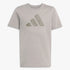 Adidas Kids Future Icons Graphic Tee in pebble gray, featuring a large textured three-stripe logo on the chest, flat-laid.