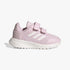 Side view of a pink Adidas Kids Tensaur Run 2.0 sneaker featuring white three stripes and two adjustable velcro straps.