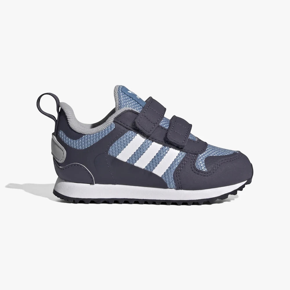 Adidas Kids Zx 700 Sneaker in navy blue with white stripes and velcro straps, side view.