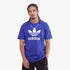 Adidas Mens Trefoil Adicolor Short Sleeve Tee in Semi Lucid Blue worn by a model, featuring the white Trefoil logo, paired