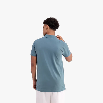 Adidas Mens Trefoil Essentials Polo Tee in blue, shown from the back on a male model wearing white shorts.