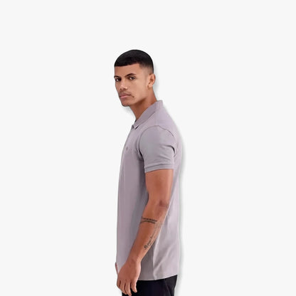 A man models an Adidas Mens Trefoil Essentials short-sleeve polo tee in grey, shown in a side profile.