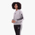A woman models an Adidas 3S Fl grey sweater with black stripes on sleeves and black Adidas leggings with white stripes.