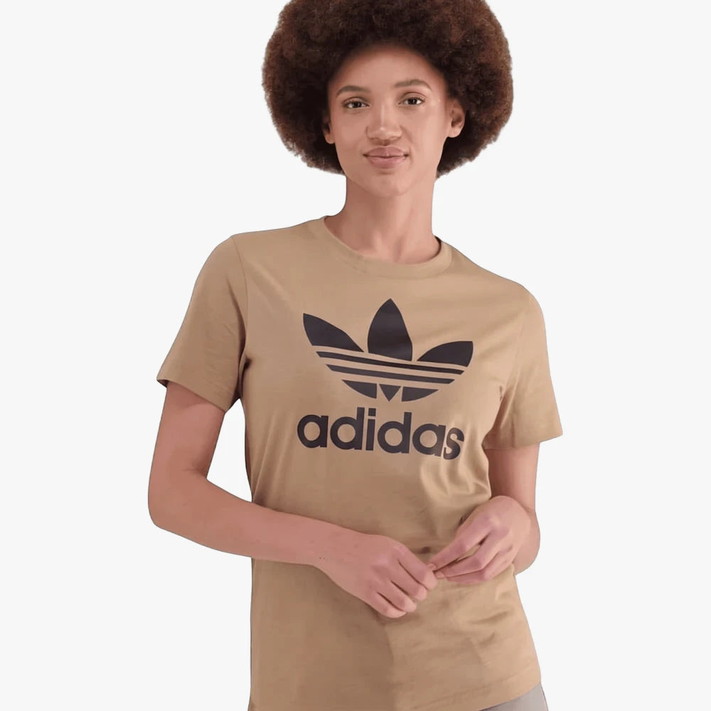 Adidas Womens Trefoil Short Sleeve Tee in cardboard color, worn by a woman with curly hair.