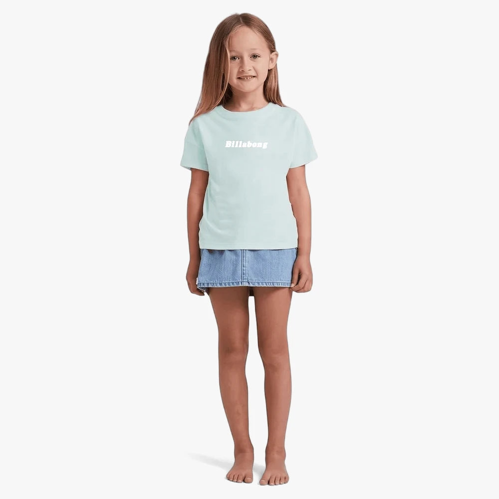 Young girl wearing a Billabong Girls Jnr Society Short Sleeve Tee in dusk blue and a denim mini skirt, full body, standing