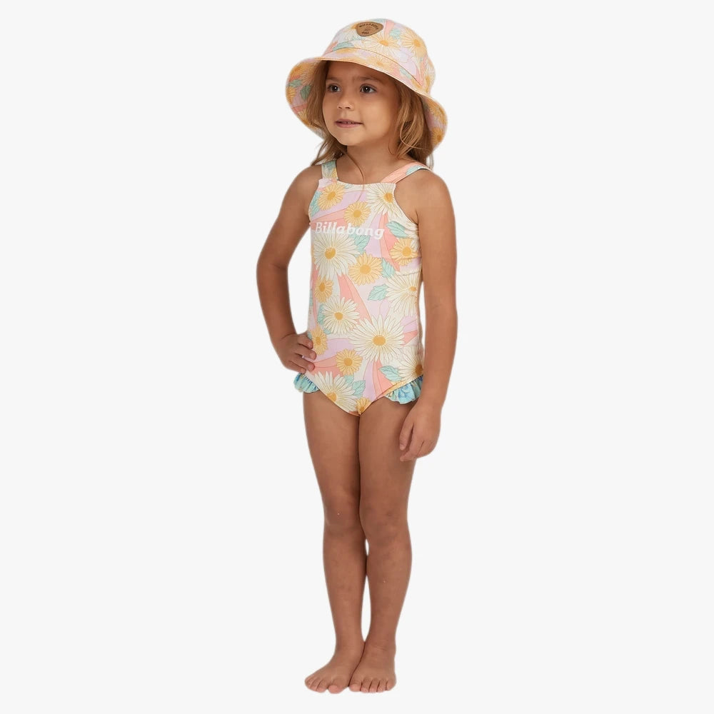 Young girl in Billabong Girls Sweet Sunset one-piece swim suit, salt crystal, with bright daisy floral print and matching