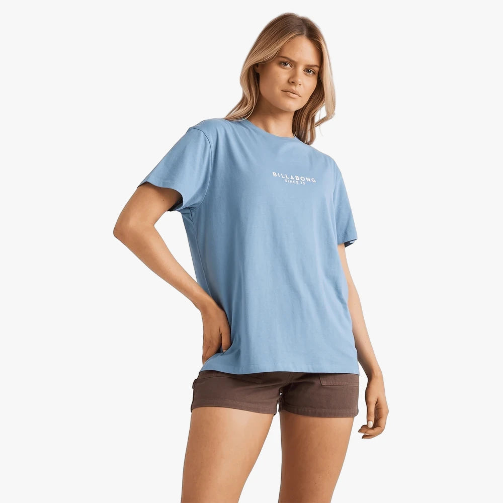 Billabong Womens Emerald Island Short Sleeve Tee in Blue Shadow, paired with brown shorts, modeled from waist-up.