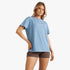Billabong Womens Emerald Island Short Sleeve Tee in Blue Shadow, paired with brown shorts, modeled from waist-up.