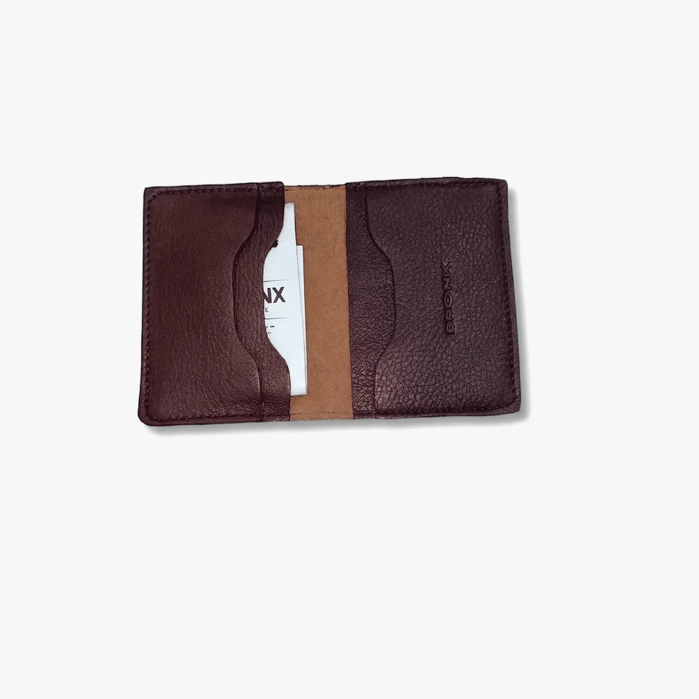 Dark brown Bronx leather cardholder wallet, open to reveal interior card slots and a white card.