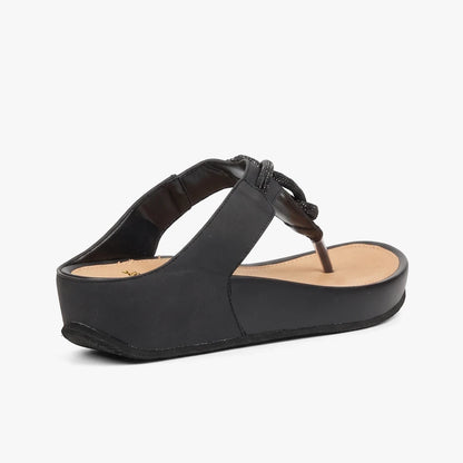 Black Butterfly Womens Delia 14 wedge sandal with a beaded thong strap, viewed from a side angle showing the elevated sole.