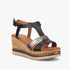 Black and metallic Butterfly Womens Melinda 1 wedge heel sandal with cork sole on a white background, side view.